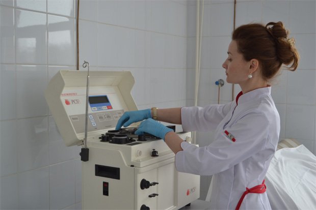 Медсестра проводит подготовку аппарата к процедуре плазмафереза